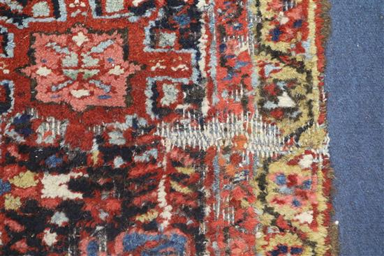 A Persian Heriz red ground carpet, 380 x 280cm, worn